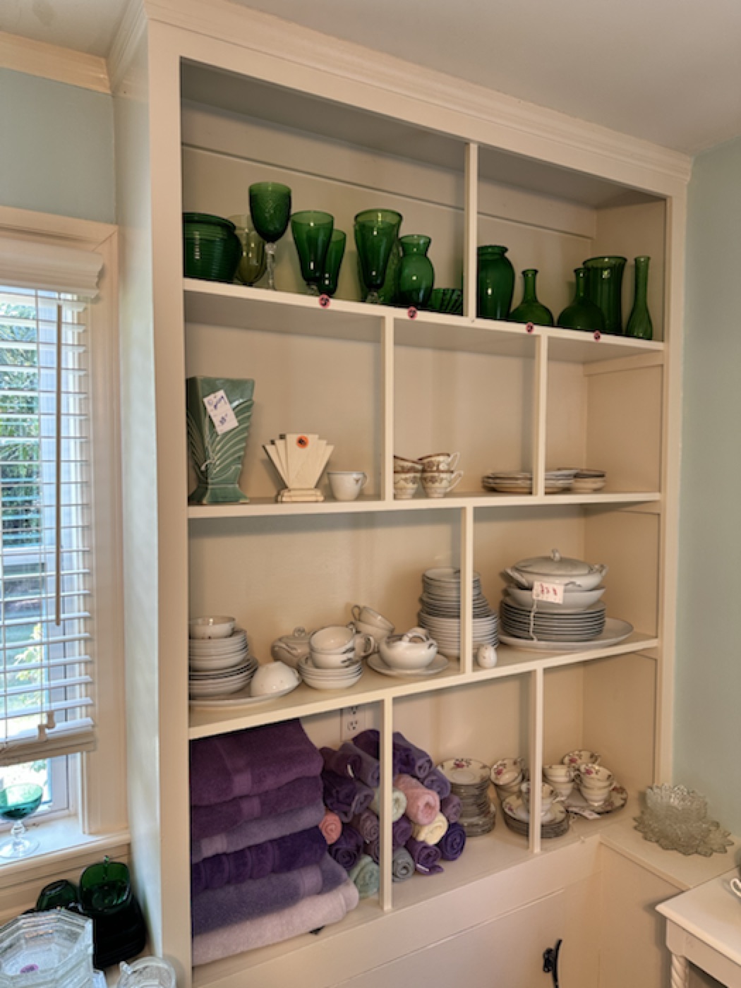 Green glass, china, and linens grouped into a cohesive color story