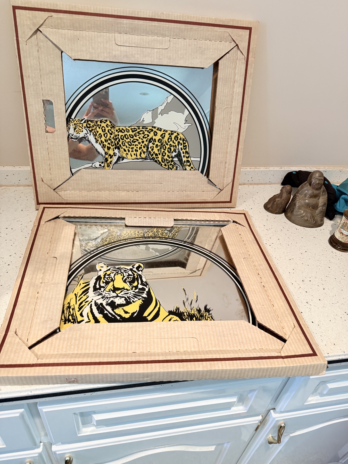 Two framed vanity mirrors decorated with leopard and tiger illustrations