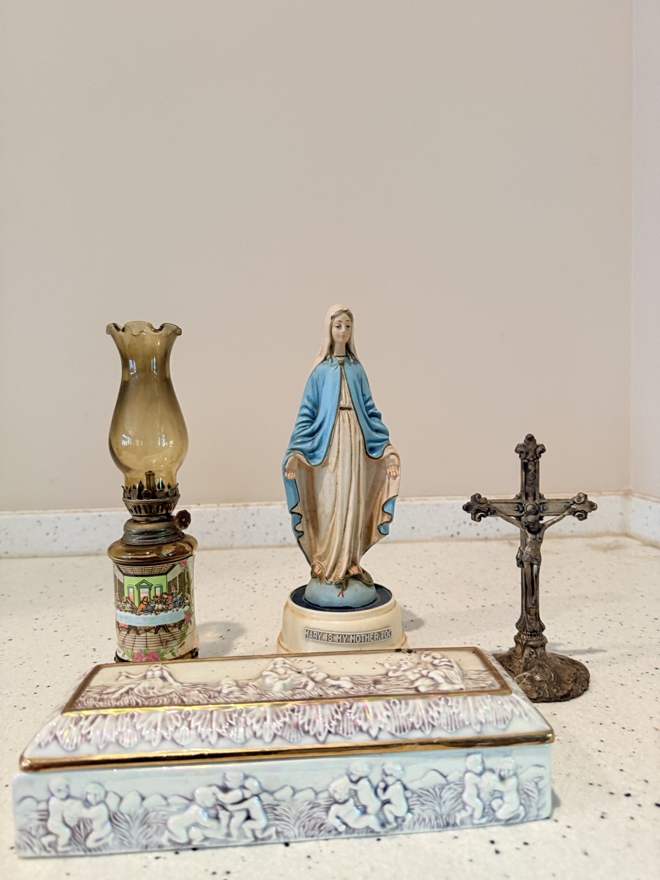 Small group of vintage devotional objects including a Madonna figure, crucifix, lamp, and decorated box