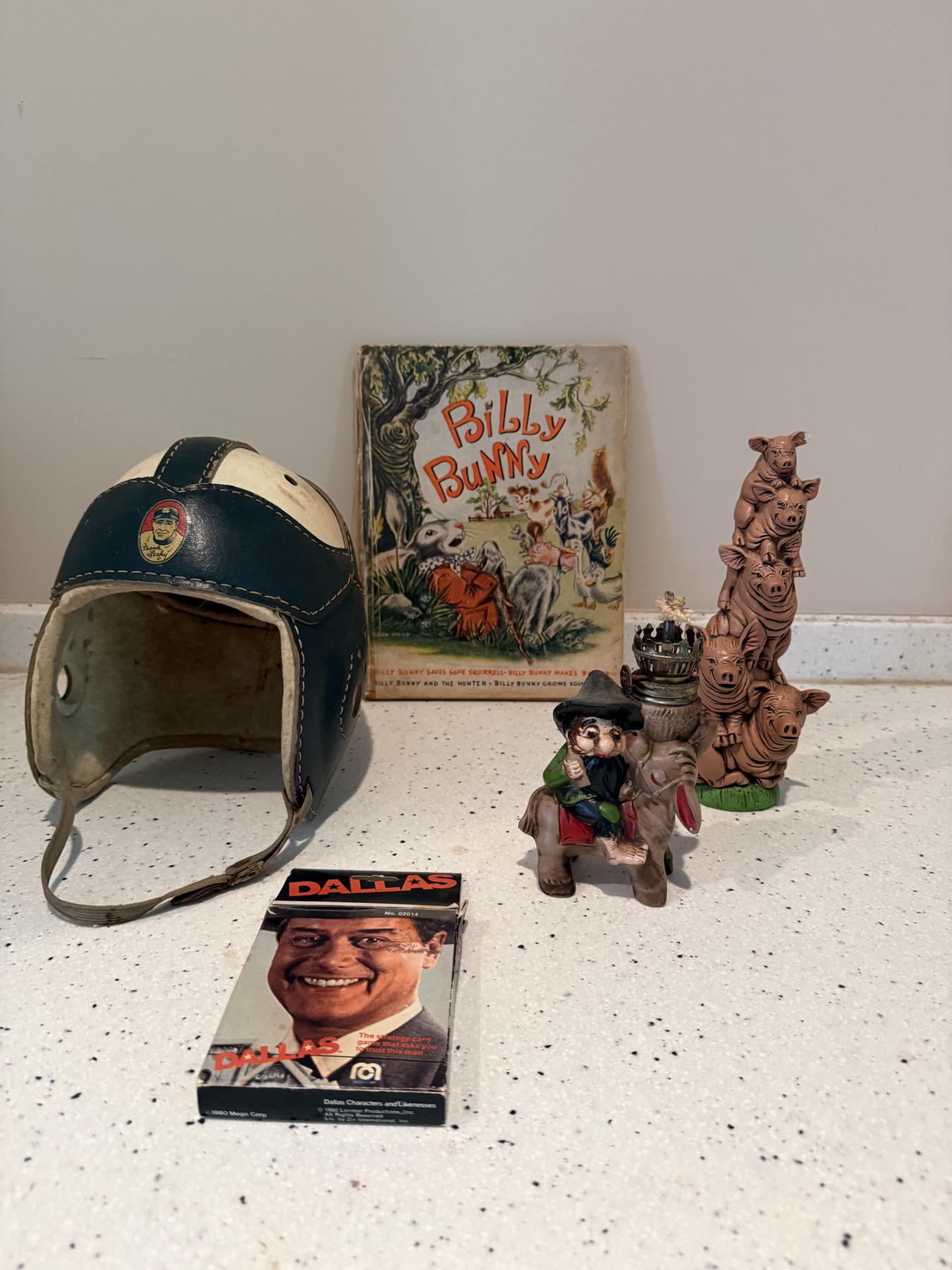 Vintage football helmet displayed with a Billy Bunny book and small character figures