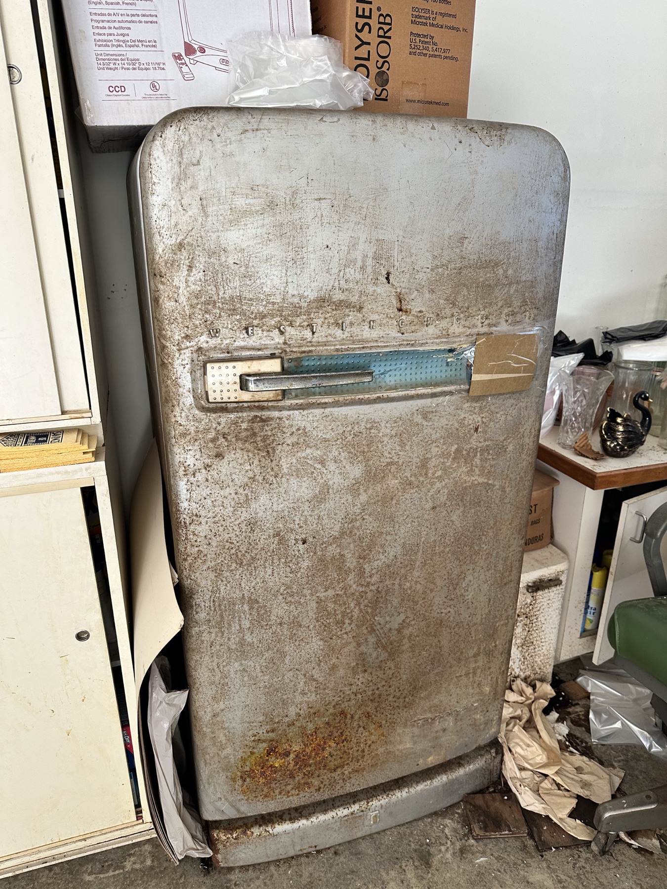 Weathered vintage Westinghouse refrigerator with chrome handle