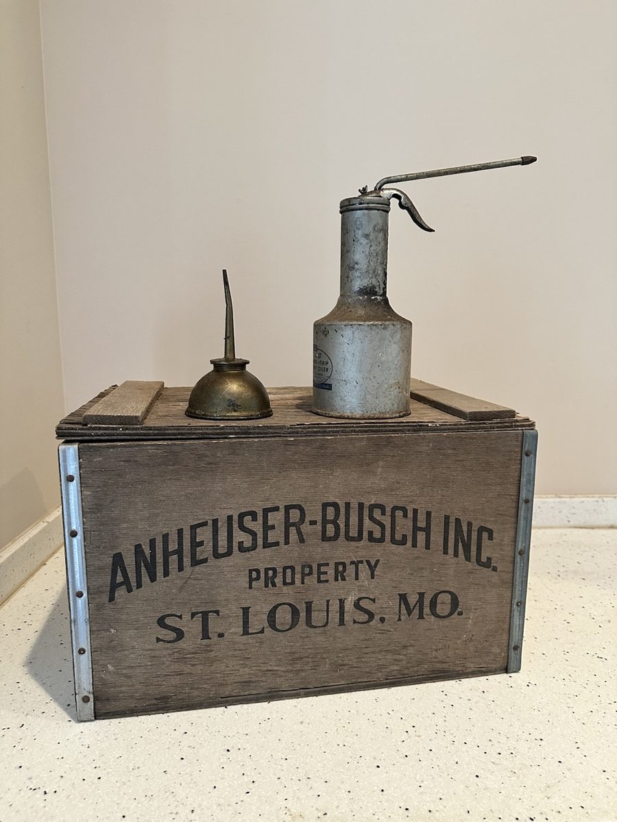 Vintage Anheuser-Busch wooden crate displayed with two metal oilers