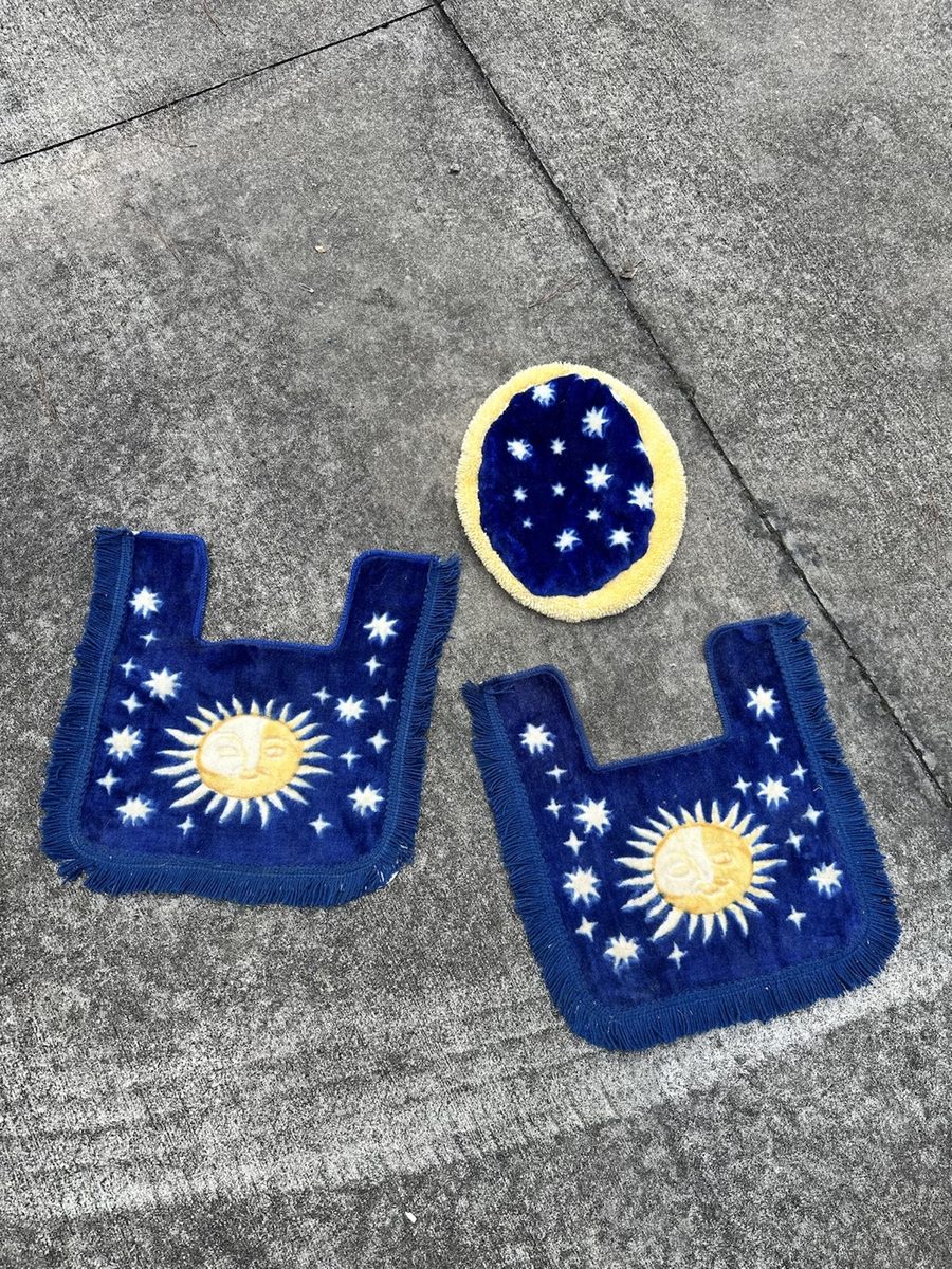 Blue embroidered textiles decorated with gold suns, moons, and stars